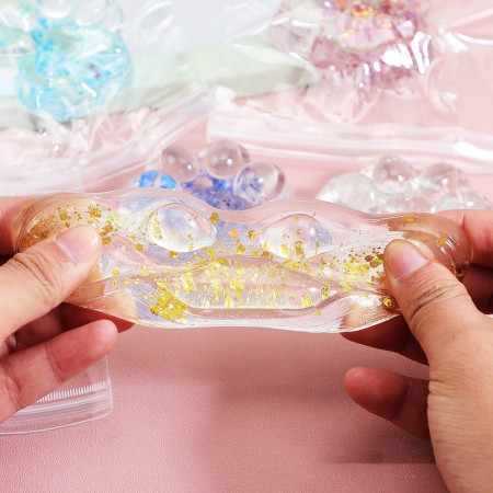 Jucarie Antistres Squishy, Cyrax, cu Revenire Lenta, Squeeze Pinch Family, Model Cat Paw, 6.5 x 7 cm, din Tpr, 4-6 Ani, Model 4 Sclipici, Transparent